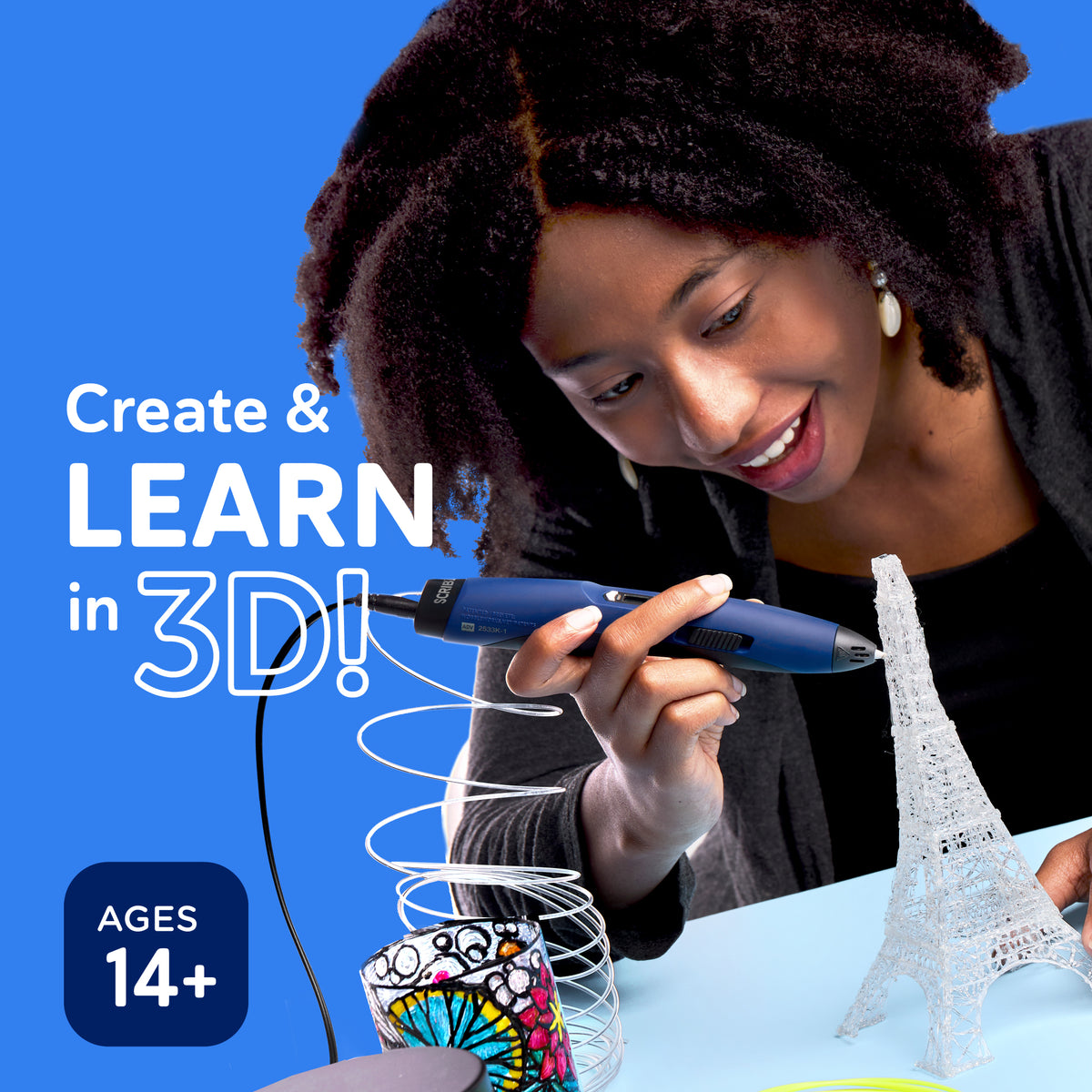 A woman using a SCRIB3D pen to create a white Eiffel Tower model. Large text reads 'Create & LEARN in 3D!' and 'AGES 14+' against a bright blue background.